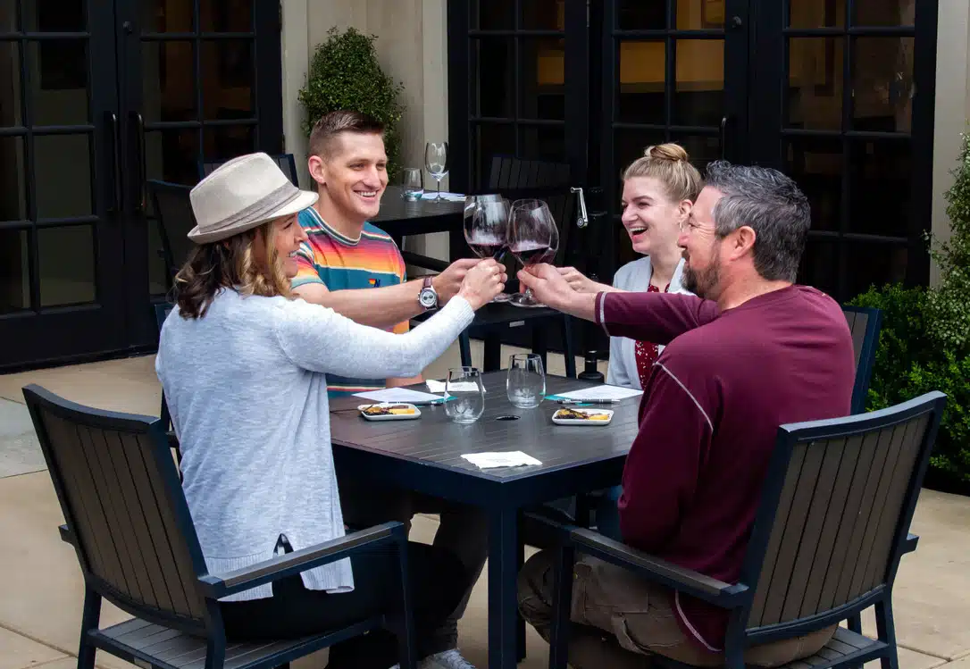 People tasting wine on patio