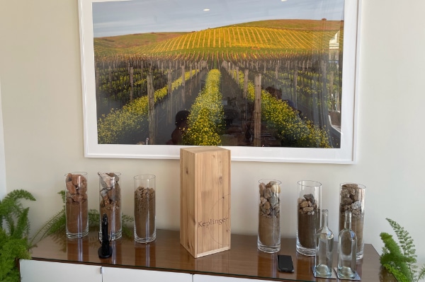 Inside the Keplinger tasting room, 6 jars of dirt from various vineyardsand beautiful picture of a vineyard