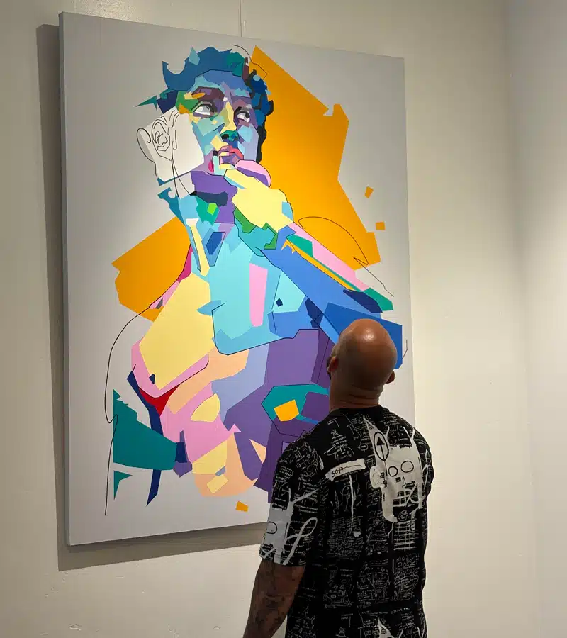 man looking at art