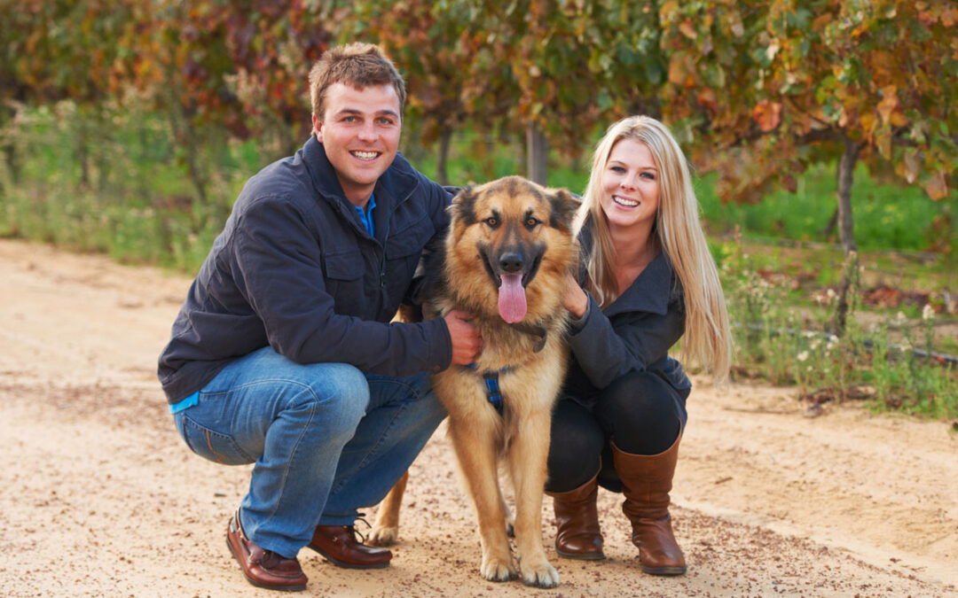 couple and dog at pet friendly winery