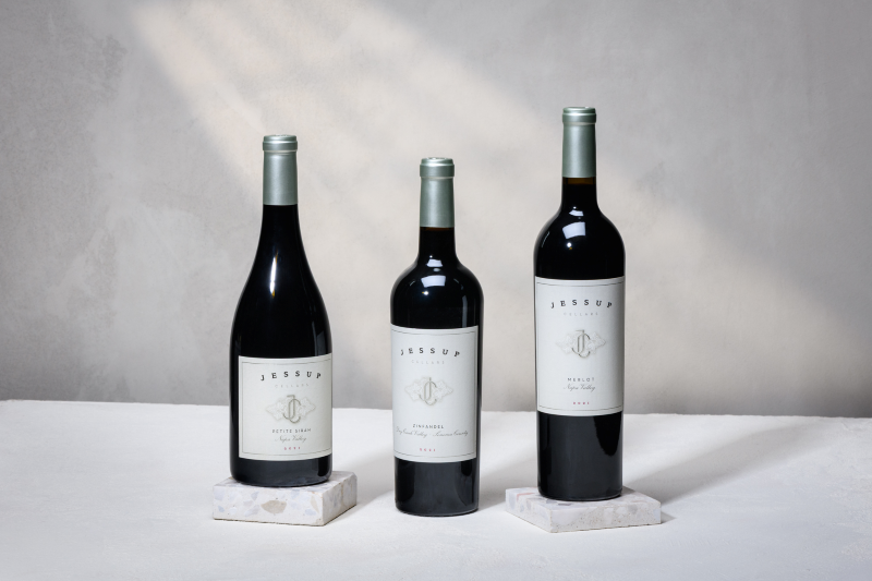 The Bold Reds Trio 2026 three wine bottles on a holiday background