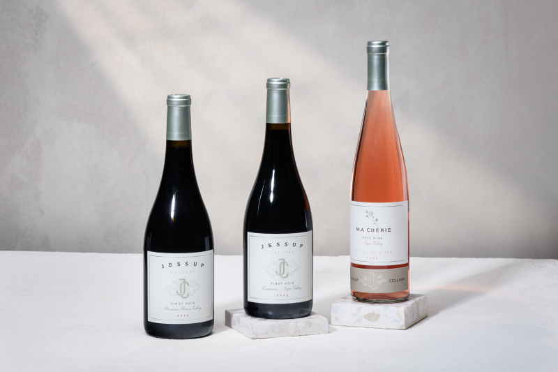 The Pinot Pack 2026 three wine bottles on a holiday background